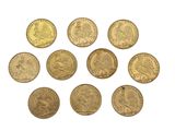 a close up of a bunch of gold coins on a white surface