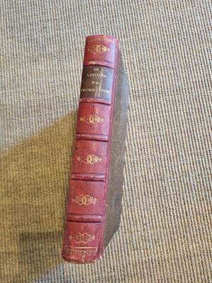 a red book sitting on top of a wooden block