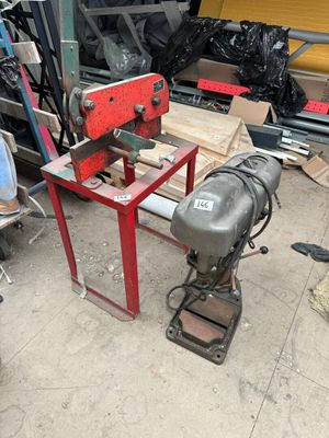 a machine that is sitting on the ground next to a pile of junk