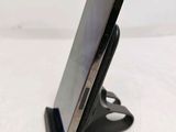a cell phone that is on a stand on the table