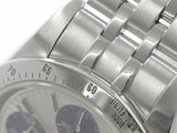 a close up of a watch on a white surface
