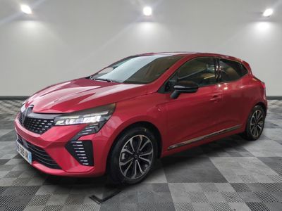 a red car parked on a checkered floor in a garage