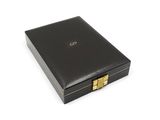 black leather box with gold hardware on a white background