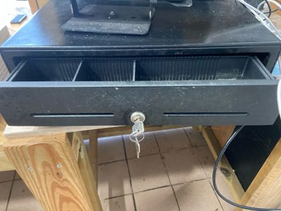 a black drawer with a computer on top of it