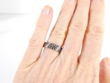 a woman ' s hand with a diamond ring on it