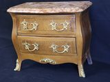 an image of a wooden chest of drawers with a marble top