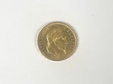 a gold coin with a picture of a woman on it
