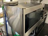 a stainless steel oven in the middle of a kitchen