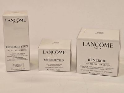 three boxes of lancomme skin care products on a white surface