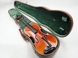 violin case with a violin in it on a white surface