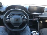 a man that is sitting in the driver ' s seat of a car