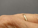 a close up of a person ' s hand with a ring on it