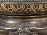 a silver plate with a decorative design on it