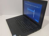 a laptop computer sitting on a table with a blue screen