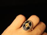 a person wearing a ring with a skull on it