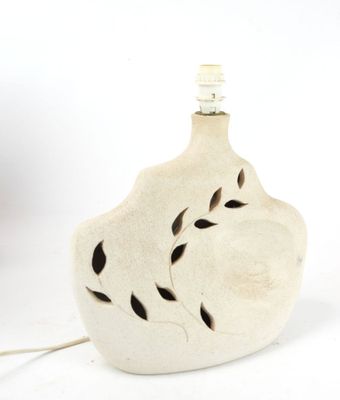 a small white vase with a light on top of it