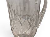 crystal glass pitcher with a handle on a white background