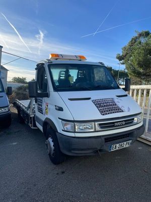 a white truck that is parked next to a fence