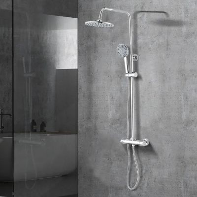 a close up of a shower head with a hand shower in a bathroom