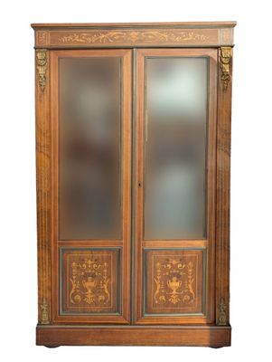 an old wooden cabinet with glass doors and a door handle