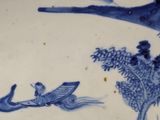 a blue and white plate with a bird on it