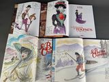 six children ' s books are lined up on a table