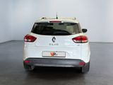 the rear end of a white car parked in a white room