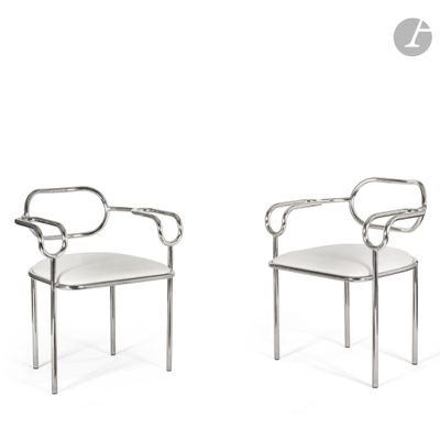 pair of chrome steel chairs with white upholstered seats