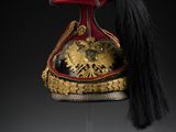 an old helmet with a long black hair on a stand
