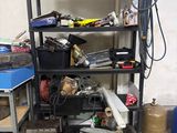 a black shelving with lots of tools on top of it