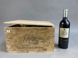 an image of a bottle of red wine next to a wooden box