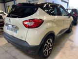 the rear end of a white car parked in a garage