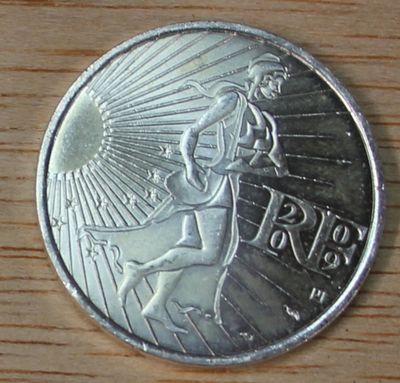 an image of a silver coin on a wooden surface