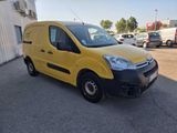 the yellow van is parked in the parking lot outside of the building