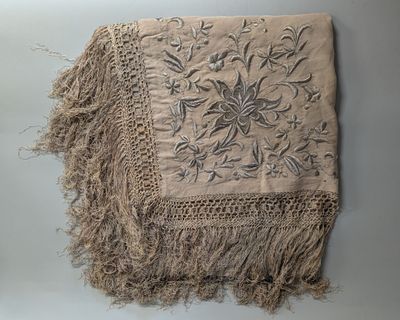 an image of a piece of cloth with fringes on a table