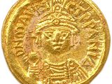 a close up of a gold coin on a white surface
