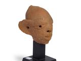 sculpture of a man ' s head on a black stand on a white background