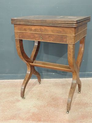 a small wooden table with a drawer on top of it