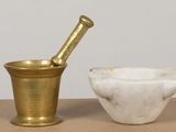 a mortar and a bowl sitting on a table