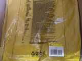 yellow nike t - shirt in a box with a price tag on it
