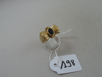 a small white and gold object with a price tag on it