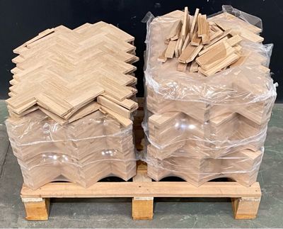 two pallets of wood are stacked on a pallet with plastic bags