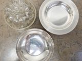 three plates and a bowl of water on the table