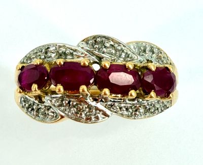 an image of a gold and ruby ring with diamonds on a white background