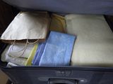 a piece of luggage that is packed with towels and blankets