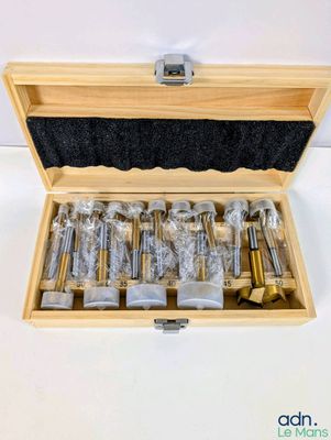 a wooden box with a bunch of screws inside of it