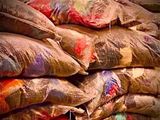 a pile of bags of sand sitting on the ground