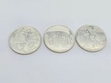 three different types of coins are shown on a white surface
