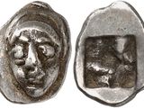a close up of a coin with a face on it