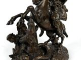 bronze statue of a man on a horse and a woman on a horse